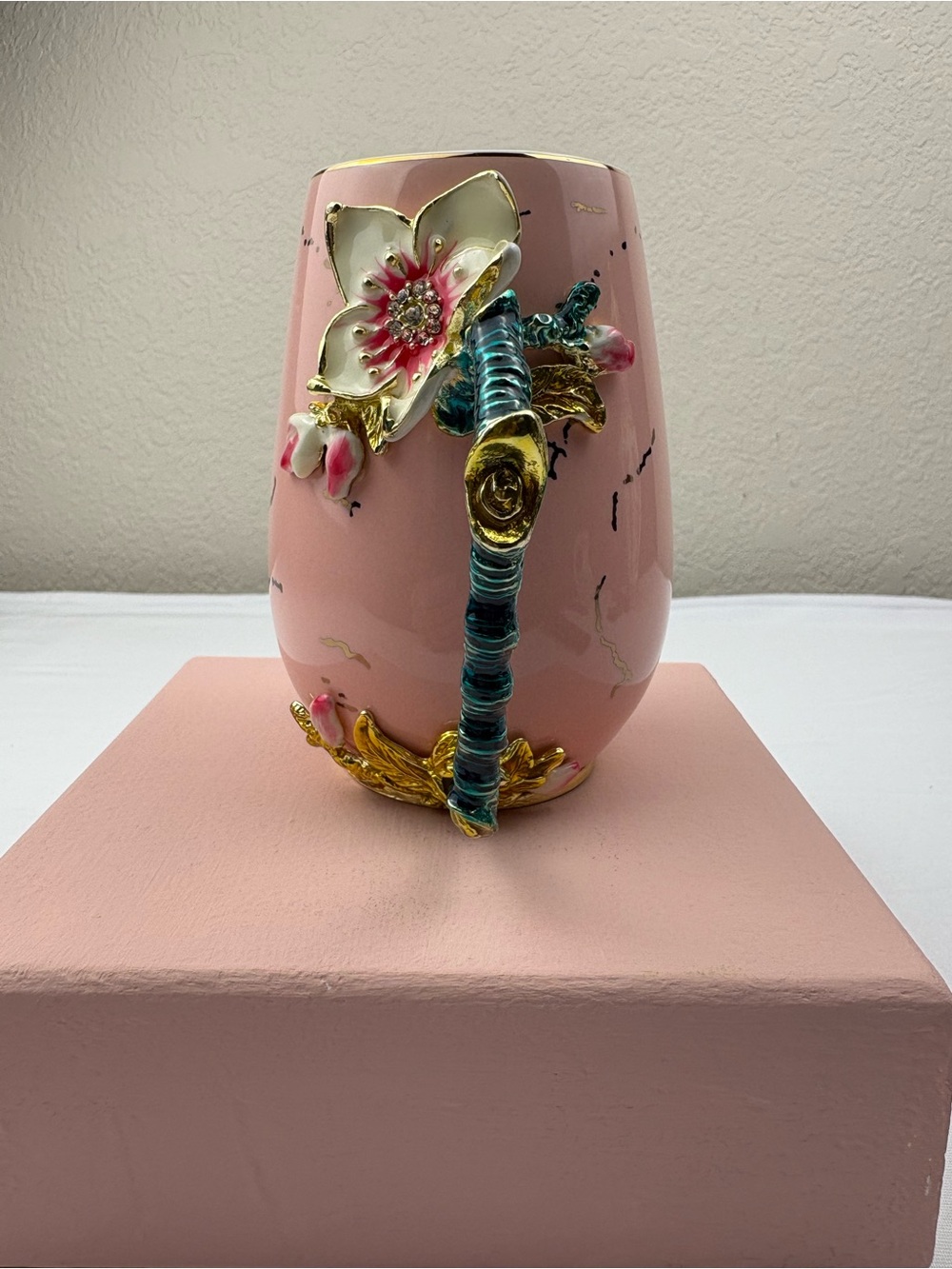 Pink ceramic enamel mug decorated with a 3D floral, rhinestones, and gold trim.